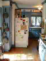 the refrigerator blocks space in this small kitchen